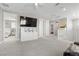 Large loft area with carpet, ceiling fan, television, multiple storage spaces, and natural light at 12413 Alpenglow Ct, Las Vegas, NV 89138