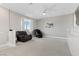 Open loft area featuring neutral carpet, a ceiling fan, and comfortable seating at 12413 Alpenglow Ct, Las Vegas, NV 89138