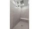Modern tiled shower featuring a rainfall shower head, built-in bench, and natural light at 12413 Alpenglow Ct, Las Vegas, NV 89138