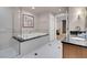 Bathroom showcasing a large soaking tub, glass shower, and vanity with black countertop and an artwork at 145 E Harmon Ave # 3801&3803, Las Vegas, NV 89109