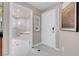Hallway view of bathroom featuring white tile and a shower at 145 E Harmon Ave # 3801&3803, Las Vegas, NV 89109