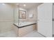 Spacious bathtub and shower with tiled walls and glass door at 145 E Harmon Ave # 3801&3803, Las Vegas, NV 89109