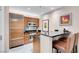 Modern kitchen featuring stainless steel appliances, granite countertops, and breakfast bar at 145 E Harmon Ave # 3801&3803, Las Vegas, NV 89109