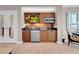 Modern kitchenette features wood cabinetry, granite countertops, and stainless steel appliances at 145 E Harmon Ave # 3801&3803, Las Vegas, NV 89109