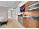 Modern kitchenette features wooden cabinets, microwave, sink, and sleek countertops at 145 E Harmon Ave # 3801&3803, Las Vegas, NV 89109