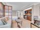Comfortable living area with sofa, glass coffee table, and kitchenette with modern stainless steel appliances at 145 E Harmon Ave # 3801&3803, Las Vegas, NV 89109