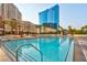 Inviting pool with lounge chairs and umbrellas offering stunning views of the surrounding buildings and palm trees at 145 E Harmon Ave # 3801&3803, Las Vegas, NV 89109