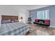 Comfortable bedroom featuring natural light, a cozy bed, and a sofa at 1455 E Katie Ave # D17, Las Vegas, NV 89119