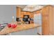 Cozy kitchen featuring wood cabinets, granite countertops, and essential appliances at 1455 E Katie Ave # D17, Las Vegas, NV 89119