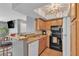 Stylish kitchen featuring wood cabinets, granite countertops, and appliances at 1455 E Katie Ave # D17, Las Vegas, NV 89119