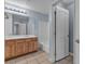 A well-maintained bathroom with double sinks, wood cabinets, and a tub, showcasing functional design at 1532 Via Cassia, Henderson, NV 89052