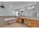 Large bathroom with a tub, dual sinks, vanity, and neutral tile at 1532 Via Cassia, Henderson, NV 89052