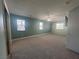 Spacious carpeted bedroom with a ceiling fan and three windows for natural light at 1532 Via Cassia, Henderson, NV 89052