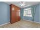 A serene bedroom featuring a large Murphy bed and a window with light blue curtains at 1532 Via Cassia, Henderson, NV 89052