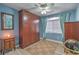 Neutral secondary bedroom with built-in wardrobe, an area rug, and a ceiling fan at 1532 Via Cassia, Henderson, NV 89052
