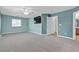 A large bedroom with a ceiling fan, tv, and an adjoining bathroom and carpet flooring at 1532 Via Cassia, Henderson, NV 89052