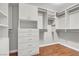 Walk-in closet with custom shelving, drawers, and ample storage space at 1532 Via Cassia, Henderson, NV 89052
