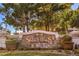 Elegant 'Seven Hills' community entrance with stone detail, landscaping, and mature trees at 1532 Via Cassia, Henderson, NV 89052