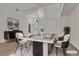 Bright dining room features a modern chandelier and sleek furniture at 1532 Via Cassia, Henderson, NV 89052
