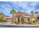 Single-story home showcasing a three-car garage, desert landscaping, and charming architectural details at 1532 Via Cassia, Henderson, NV 89052