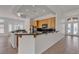 Open kitchen with wooden cabinets, black granite countertops, and a breakfast bar overlooking the entry at 1532 Via Cassia, Henderson, NV 89052