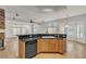 Stylish kitchen with black appliances and countertop bar that opens to the living room at 1532 Via Cassia, Henderson, NV 89052