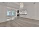 Open living area with a fireplace and beautiful chandelier at 1532 Via Cassia, Henderson, NV 89052