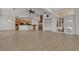 Open concept living room with tile floors, stone fireplace, and sliding glass doors to the outdoor space at 1532 Via Cassia, Henderson, NV 89052