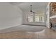 Cozy living room with a stone fireplace and views of the pool at 1532 Via Cassia, Henderson, NV 89052