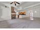 Spacious living room view showcasing stone fireplace with open floorplan and kitchen at 1532 Via Cassia, Henderson, NV 89052