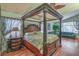 Spacious main bedroom with a four-poster bed, wood floors, and sitting area, with bright natural light at 1532 Via Cassia, Henderson, NV 89052