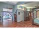 Bright main bedroom with wood floors, and glass doors leading to a hot tub, and a built in entertainment center at 1532 Via Cassia, Henderson, NV 89052