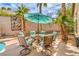 Patio dining area with a table, chairs, and umbrella, perfect for outdoor entertaining at 1532 Via Cassia, Henderson, NV 89052