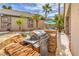 Outdoor kitchen area featuring a grill and stone accents near a relaxing pool area at 1532 Via Cassia, Henderson, NV 89052