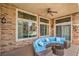 Relaxing covered patio featuring stone accents, comfortable seating, and views of the sparkling pool at 1532 Via Cassia, Henderson, NV 89052