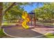 Community playground with a colorful slide and shade trees offers a fun place for children at 1532 Via Cassia, Henderson, NV 89052