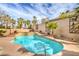 Backyard pool with a tanning ledge, water feature, and lush landscaping at 1532 Via Cassia, Henderson, NV 89052