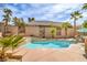 Inviting backyard pool with a tanning ledge, water feature, and lush landscaping at 1532 Via Cassia, Henderson, NV 89052