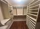 Walk-in closet with custom shelving and hardwood floors, perfect for organizing at 1532 Via Cassia, Henderson, NV 89052