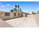 View of the backyard with concrete patio, desert landscaping, and secure fencing for privacy and low maintenance at 1655 E Hacienda Ave, Las Vegas, NV 89119