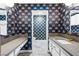 Elegant bathroom featuring double vanity, bold wallpaper, and marble flooring at 1655 E Hacienda Ave, Las Vegas, NV 89119