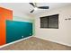 Bedroom with ceiling fan, green and orange accent wall and window at 1655 E Hacienda Ave, Las Vegas, NV 89119