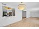 Dining room showcasing modern light fixture and view into kitchen at 1655 E Hacienda Ave, Las Vegas, NV 89119