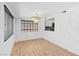 Bright dining area featuring hardwood floors, a modern chandelier, and plenty of natural light with access to kitchen at 1655 E Hacienda Ave, Las Vegas, NV 89119