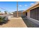 Side view of a single-story home featuring desert landscaping and solar panels on the roof at 1655 E Hacienda Ave, Las Vegas, NV 89119