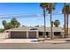 Well-maintained home with a spacious two-car garage, palm trees, and neatly manicured landscaping at 1655 E Hacienda Ave, Las Vegas, NV 89119