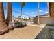 Charming desert-landscaped front yard with mature palm trees and a small decorative fence at 1655 E Hacienda Ave, Las Vegas, NV 89119