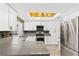 A modern kitchen featuring quartz countertops, stainless appliances, and a stunning tile backsplash and flooring at 1655 E Hacienda Ave, Las Vegas, NV 89119