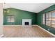 Bright living room featuring a cozy fireplace, hardwood floors, and ample natural light from large windows at 1655 E Hacienda Ave, Las Vegas, NV 89119