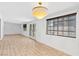 Large living room with hardwood floors, big window, and double doors leading to a patio at 1655 E Hacienda Ave, Las Vegas, NV 89119